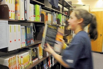 Katie Pruss, a junior and student librarian, returns one of about 200 textbooks that are on reserve at the Robert Morris University library.