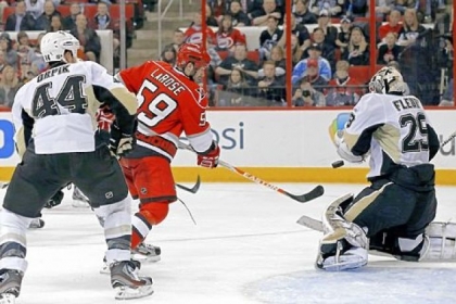 The Hurricanes' Chad LaRose gets a shot on Penguins goalie Marc-Andre Fleury Thursday in Raleigh, N.C.