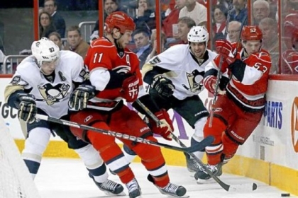 Hurricanes center Jordan Staal fights for the puck last night against Penguins center Sidney Crosby in the second period.