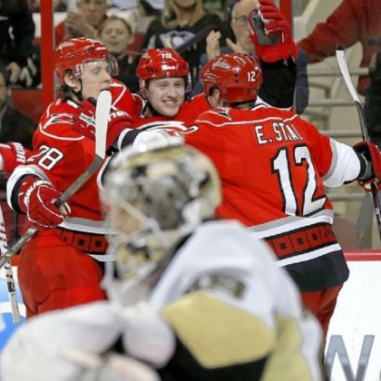 The Hurricanes' Jiri Tlusty, center, celebrates his goal with teammates Alexander Semin, left, and Eric Staal as Penguins goalie Marc-Andre Fleury reacts in the foreground Thursday in Raleigh, N.C. The Penguins lost, 4-1.