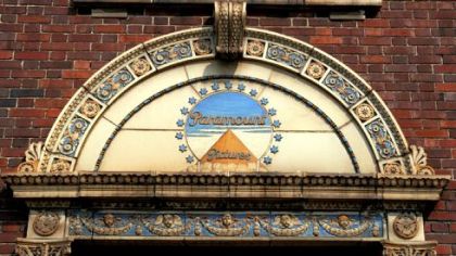 The old Paramount Pictures emblem still stands above the door to the entrance of the former Paramount Film Exchange on Miltenberger Street and the Boulevard of the Allies, Uptown.