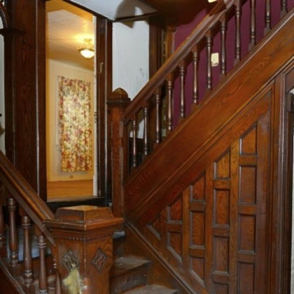 This five-bedroom home in Beaver features original woodwork, as shown on the left, detailed newel posts and bannisters that highlight the staircase.