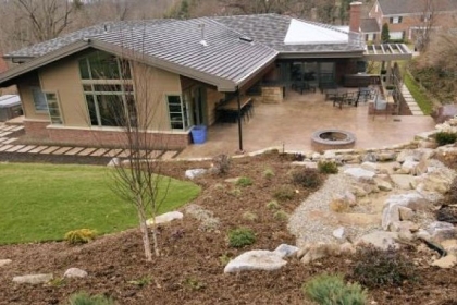Rear view of family room windows and patio with fire pit at McQuaide house.