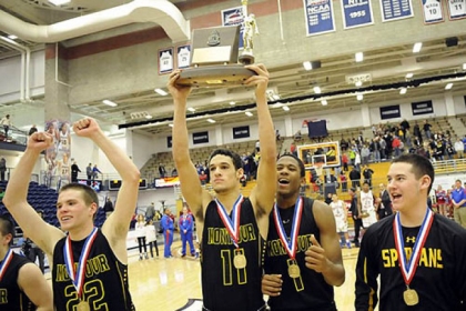 Montour's Devin Wilson holds the trophy with his teammates after defeating Chartiers Valley in the WPIAL class AAA championship Friday night at Palumbo Center.