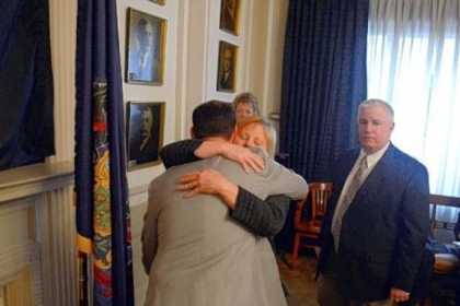 Mayor Luke Ravenstahl hugs his mother, Cindy, and father, Robert, after announcing the end of his re-election bid Friday.