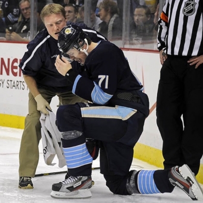 Evgeni Malkin is helped up after taking a hit along the boards in the third period. He left the game Feb. 22 and did not return.