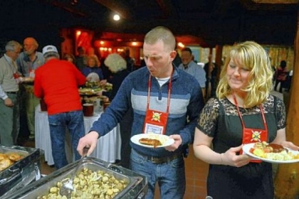 Sean Kluge and Tiffany Barr of Lancaster go through the buffet line during a Wounded Warriors banquet. They served in Afghanistan in the Army in 2011-12 and are now engaged.