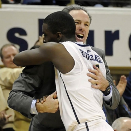 Coach Jamie Dixon hugs senior Tray Woodall as he exits the game in overtime.
