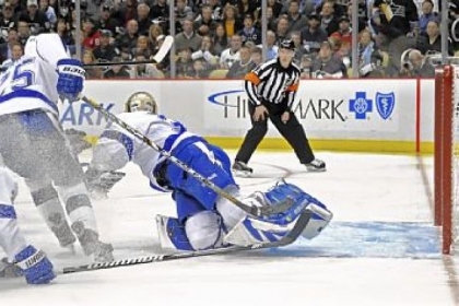 Evgeni Malkin scores the tying against Lightning goaltender Anders Lindback in the third period Monday at Consol Energy Center.