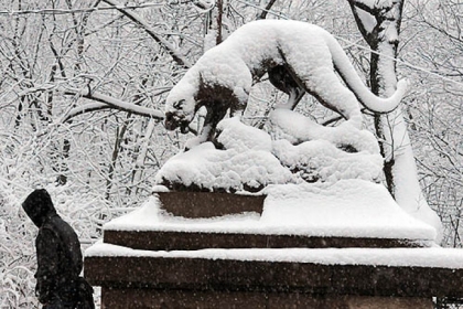 Snow covers the panther statues at the Panther Hollow Bridge in Schenley Park early wednesday morning.