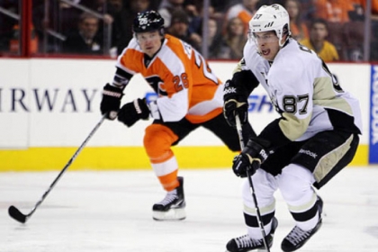 The Penguins' Sidney Crosby, right, brings the puck up ice trailed by the Flyers' Ruslan Fedotenko in the first period.