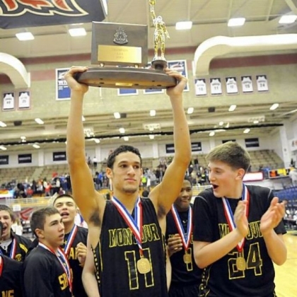 Montour's Devin Wilson holds the trophy after defeating Chartiers Valley in the WPIAL Class AAA championship last Friday night.