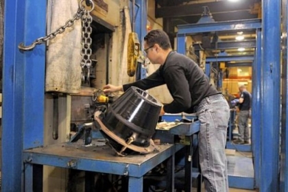 Jason D'Allessandro removes a stripper rubber from the oven and loads another one at Washington Rotating in Washington County. The rubber piece takes an hour to bake. The rubber inserts are used in the rotating control head the company manufactures for drill rigs and ships worldwide.