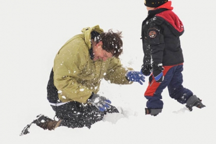 Steven Annegarn of Friendship finds himself on the receiving end of a handful of snow from his son Leo, 6, during a visit to Flagstaff Hill.