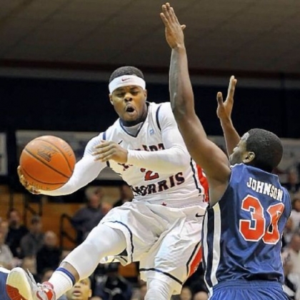 Robert Morris' Velton Jones looks to pass the ball under the basket against St. Francis' Akeem Johnson.