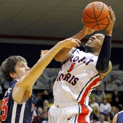 Robert Morris' Mike McFadden drives to the net against St. Francis' Alex Isailovic.
