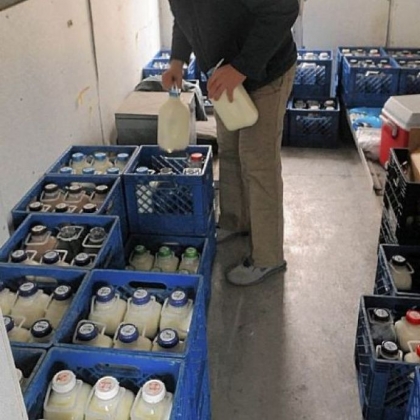 Jeff Brunton collects bottles of milk from the back of his delivery truck.