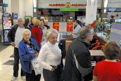 People wait in line to get their blood pressure checked before the start of the walk at Westmoreland Mall.
