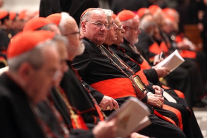 Archbishop of New York, Cardinal Timothy Dolan, center, attends a meeting of prayer Wednesday at St. Peter's Basilica with cardinals gathered for the conlave in Vatican City.