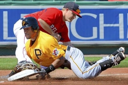 Starling Marte slides safely into third Wednesday, avoiding a tag from Boston's Brock Holt in the PIrates' 9-3 win in Fort Myers, Fla.