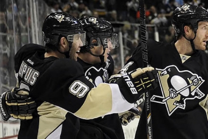 Penguins defenseman Brooks Orpik, right, sporting his distinct no-visor look, congratulates Sidney Crosby along with Pascal Dupuis in a game last month.