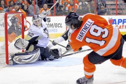 Penguins goaltender Tomas Vokoun, left, in as a mid-game replacement for Marc-Andre Fleury, makes a save on a shot by the Flyers' Scott Hartnell in the second period Thursday in Philadelphia. The Penguins came back from an early deficit to win, 5-4.
