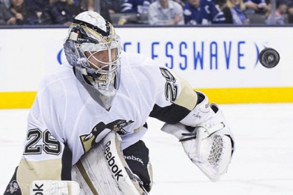 The Penguins' goaltender Marc-Andre Fleury makes a save in the second period.