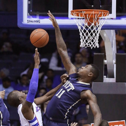 Forward Dante Taylor, center, blocks the shot of DePaul guard Worrel Clahar, left, as Derrell Robertson Jr., right, is blocked out during the first half this afternoon in Rosemont, Ill.