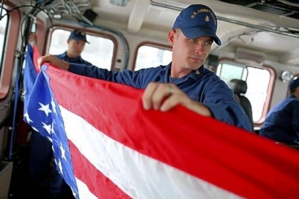Also on the cutting board  Chief Petty Officer Sean Keeman of the U.S. Coast Guard cutter Hawksbill folds an American flag while on patrol Thursday in the Pacific Ocean off the coast of San Francisco. The Coast Guard is facing more than $400 million in sequester budget cuts that will reduce patrols by 25 percent.