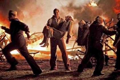 Maximilian Simonischek carries Lauren Lee Smith away from the Hindenburg crash in the miniseries "Hindenburg: The Last Flight," airing at 8 p.m. Monday and Tuesday on Encore.