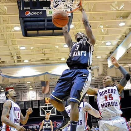 Mount St. Mary's Sam Prescott dunks in front of Robert Morris' Mike McFadden, left, and Karvel Anderson in the second half of the Colonials' NEC semifinal loss Saturday at Sewall Center.