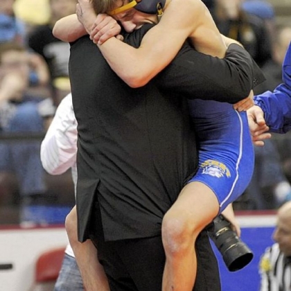 Derry Area's George Phillippi leaps into the arms of coach Mike Weinell after defeating South Fayette's Seth Garr in the PIAA Class AA final at 113 pounds Saturday in Hershey, Pa.