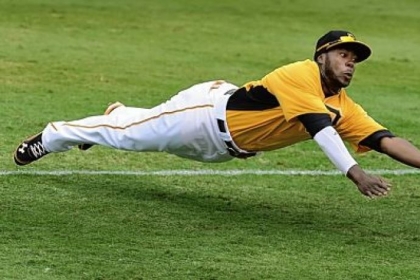 Second baseman Josh Harrison dives for a ball hit by Minnesota's Jamey Carroll in the Pirates' 5-4 exhibition loss to the Twins Saturday at McKechnie Field in Bradenton, Fla.