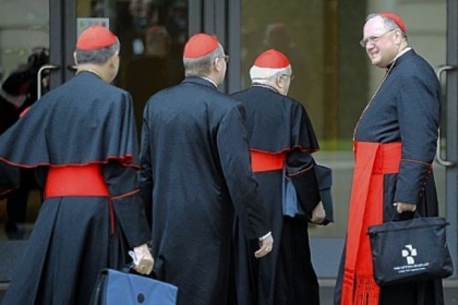 Cardinal Timothy M. Dolan, archbishop of New York, right, arrives Saturday for a pre-conclave meeting at the Vatican.