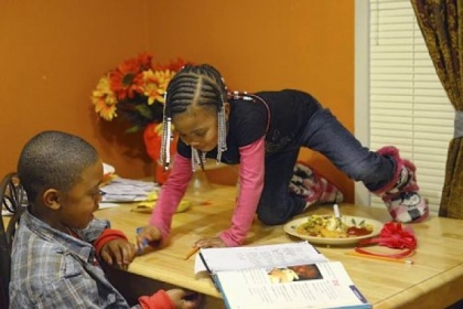The Perrin children, Archie and Katheryn, do homework and eat dinner together at their home in Duquesne.