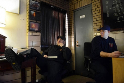 Engine House 17 firefighters Kevin Murphy, left, and Dan Reiser list the groceries they'll need for a lunch of Cuban sandwiches and a Greek chicken dinner. Early that morning firefighters went out on a call to help a woman going into labor.