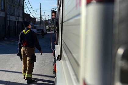 Firefighter Dan Reiser, left, speaks with firefighter Bill Gilchrist after finishing up on a call for sparking power lines on Friday, Jan. 18, 2013.
