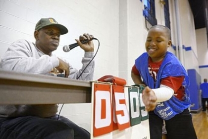 Quameir attends to the scoreboard while Clarence Battle of the Hill District calls the game. Mr. Battle, a recreation leader, has been associated with the Ammon Recreation Center for more than 30 years.