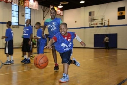Quameir Bostic, 9, of Lincoln-Lemington dribbles past Morgen Daniels, 10, of the Hill District during an Ozanam basketball program scrimmage Wednesday at the Ammon Recreation Center in the Hill District.