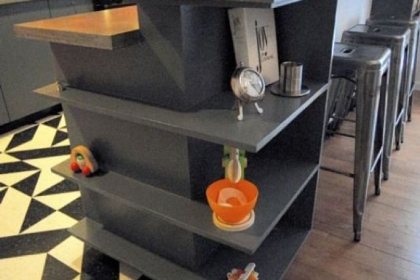 Owner-built shelves in the bar between the kitchen and dining room in the Swissvale home of Sean Derry and Coreen Farris.