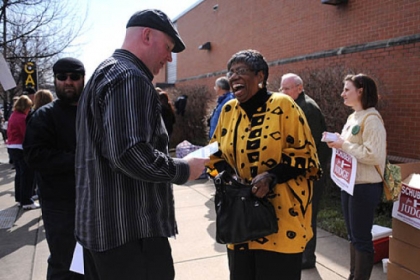 McKeesport committeewoman Laura Jenkins gets some candidate information from Joe Bendel as she enters the IBEW building on the South Side to vote during the Allegheny County Democratic Committee endorsement meeting Sunday.