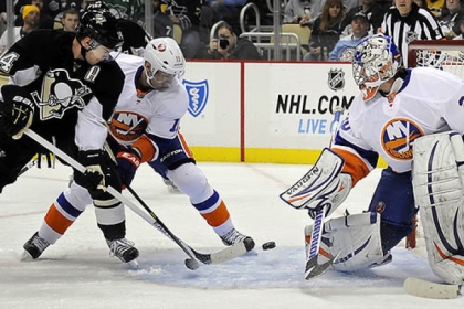 Chris Kunitz gets around the Islanders' Lubomir Visnovsky to score on goaltender Evgeni Nabokov for his first goal in the first period.