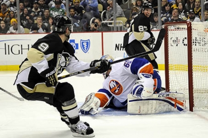 Pascal Dupuis scores his second goal of the game against Islanders goaltender Kevin Poulin in the third period. at Consol Energy Center.