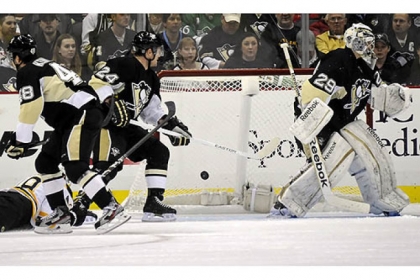 The Bruins' Tyler Seguin, bottom left, scores on Penguins goaltender Marc-Andre Fleury in the first period at Consol Energy Center.