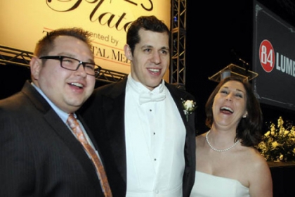 Jeff and Samantha Hollack flank Evgeni Malkin.