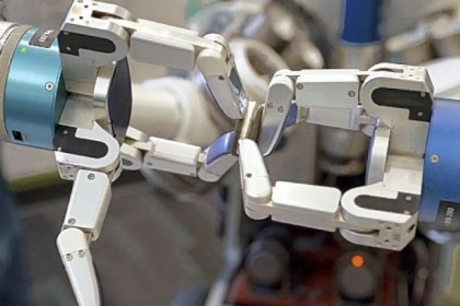 Carnegie Mellon's HERB robot pulls apart an Oreo cookie.
