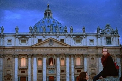 Two women sit in St. Peter's Square in front of the basilica Monday in Vatican City. Cardinals are set to enter the conclave today to elect a successor to Pope Benedict XVI.