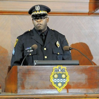 Former Sgt. Eric Holmes speaks after being promoted to the rank of Commander.