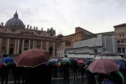Spectators watch black smoke rising as rain falls this morning in Vatican City.