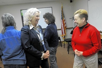 Marty Stahl, left, of Squirrel Hill and Sharon Janitor of Etna take part in a laughter workshop led by Julie Ann Sullivan at the Volunteers of America office in Sharpsburg.